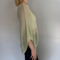 Sage green oversized sheer knit poncho sweater for women, side profile view showing lightweight breathable knit fabric, relaxed boho fit, coastal chic cover up top, summer layering piece, and vacation-ready resort wear.