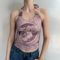 Soft pink floral halter top with silver ring straps, stretchy Y2K tank top styled with blue denim jeans. Feminine coquette aesthetic clothing featuring vintage-inspired floral print, fitted silhouette, and soft girl fashion vibe. Trendy fairycore summer top perfect for Pinterest outfits, going out looks, and everyday streetwear styling.