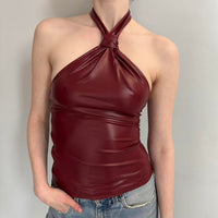 Burgundy faux leather halter top, women’s going out top, wine red party top, Y2K fashion clothing, fitted halter neck top, date night outfit, clubwear top, trendy statement top, faux leather fashion, girls night outfit, concert outfit, dark feminine aesthetic, and stylish nightlife clothing.