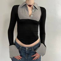 Front view of black and grey office siren contrast collared top for women with long sleeves, fitted stretchy Y2K going out top, corporate chic blouse with pointed hem and oversized cuffs, trendy boutique fashion top paired with low rise denim skirt.