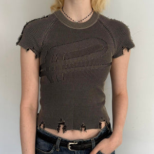 Front view of distressed ribbed baby tee in washed brown featuring raw frayed hems, fitted stretchy knit fabric, and vintage-inspired Y2K grunge design. Trendy indie sleaze women’s top styled with low rise denim for a cool girl Pinterest aesthetic outfit.