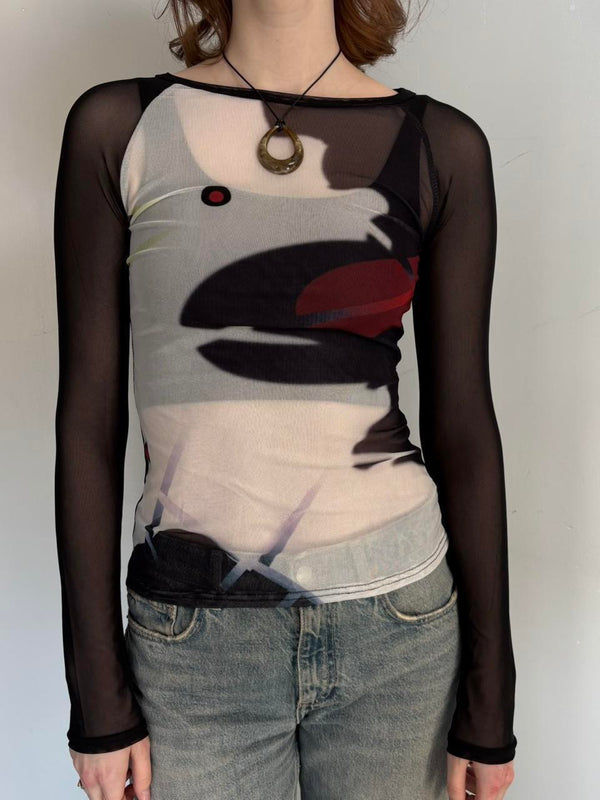 Front view of black sheer mesh graphic top for women with long sleeves, fitted stretchy Y2K going out top, abstract print cool girl blouse, trendy boutique fashion shirt paired with denim jeans, sheer streetwear top.