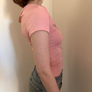 Side view of pink fitted crop top for women, stretchy Y2K baby tee style with short sleeves, slim fit casual summer top, trendy coquette aesthetic outfit paired with low rise denim jeans, minimalist boutique fashion look.