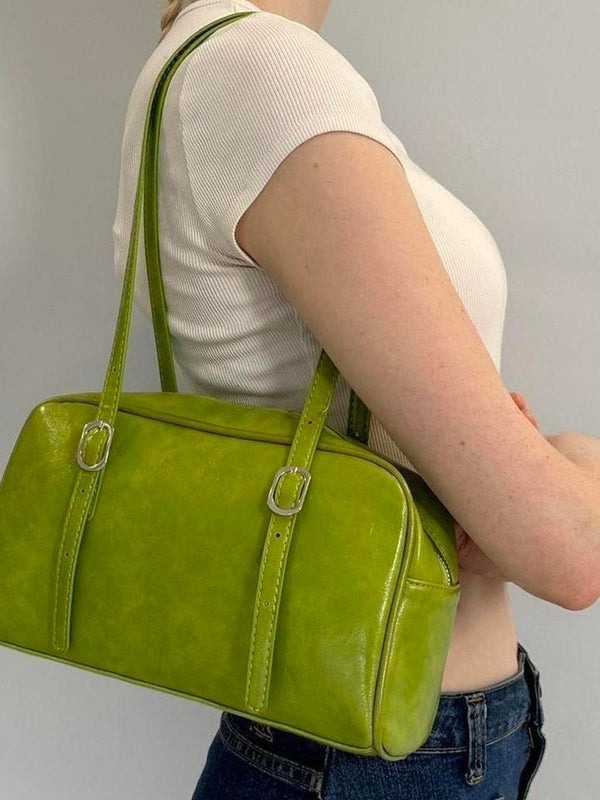 Lime green Y2K shoulder bag, glossy baguette purse with adjustable buckle straps, trendy 2000s aesthetic handbag styled with white ribbed tee and denim jeans, statement street style accessory for women