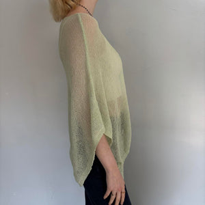 Sage green oversized sheer knit poncho sweater for women, side profile view showing lightweight breathable knit fabric, relaxed boho fit, coastal chic cover up top, summer layering piece, and vacation-ready resort wear.