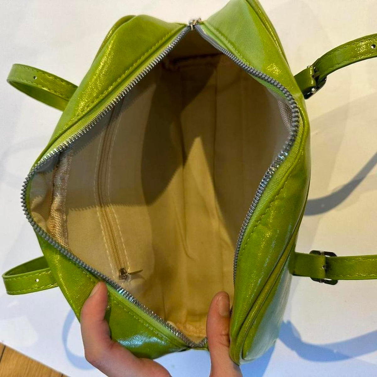Lime green Y2K shoulder bag interior view, open glossy faux leather baguette purse with zipper closure and beige lining, spacious mini handbag with inner pocket detail, vintage-inspired 2000s aesthetic accessory for everyday use