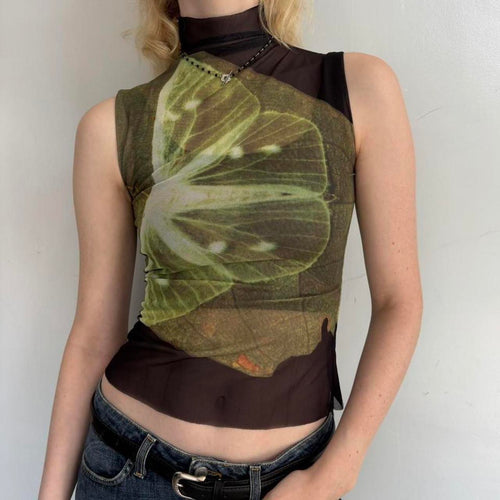 Model wearing lime slice mesh asymmetrical top with sheer black mock neck design, Y2K graphic sleeveless tank top, trendy women’s going out top paired with low rise jeans.