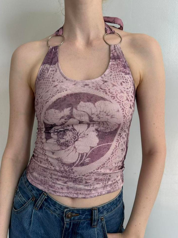 Soft pink floral halter top with silver ring straps, stretchy Y2K tank top styled with blue denim jeans. Feminine coquette aesthetic clothing featuring vintage-inspired floral print, fitted silhouette, and soft girl fashion vibe. Trendy fairycore summer top perfect for Pinterest outfits, going out looks, and everyday streetwear styling.