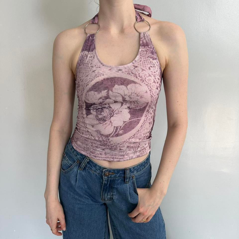 Pink floral halter top with silver ring details and vintage-inspired lace print, styled with blue denim jeans. Stretchy Y2K aesthetic tank top featuring soft girl, coquette, and fairycore fashion vibes. Trendy fitted polyester cami perfect for summer outfits, going out looks, Pinterest fashion inspiration, and feminine streetwear styling.