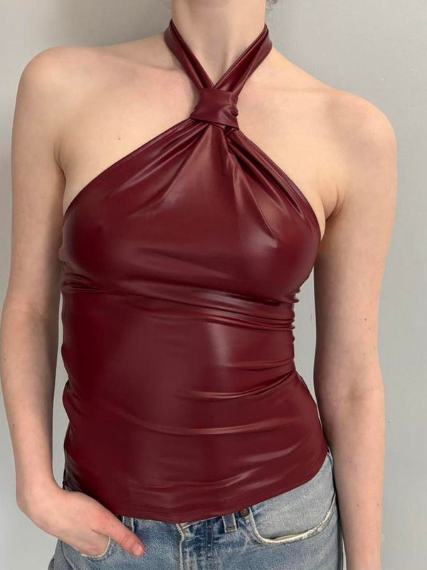 Burgundy faux leather halter top, women’s going out top, wine red party top, Y2K fashion clothing, fitted halter neck top, date night outfit, clubwear top, trendy statement top, faux leather fashion, girls night outfit, concert outfit, dark feminine aesthetic, and stylish nightlife clothing.