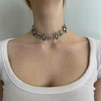 Antique-style silver pearl choker necklace for women with floral filigree accents, vintage statement jewelry, romantic coquette accessory, Victorian-inspired necklace, cottagecore fashion piece, and feminine silver choker styled on a model.