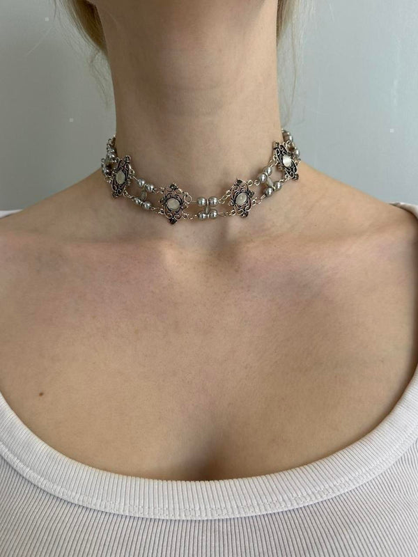 Antique-style silver pearl choker necklace for women with floral filigree accents, vintage statement jewelry, romantic coquette accessory, Victorian-inspired necklace, cottagecore fashion piece, and feminine silver choker styled on a model.