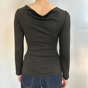 Back view of black long sleeve fitted top for women with soft draped cowl back neckline, stretchy polyester Y2K going out top, trendy boutique fashion shirt, sleek black bodycon top paired with jeans.