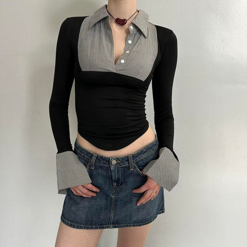 Black and grey office siren contrast collared top for women with long sleeves, fitted stretchy Y2K going out top, trendy corporate chic blouse with pointed hem and statement cuffs, boutique fashion top paired with denim mini skirt.