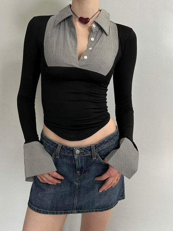 Black and grey office siren contrast collared top for women with long sleeves, fitted stretchy Y2K going out top, trendy corporate chic blouse with pointed hem and statement cuffs, boutique fashion top paired with denim mini skirt.